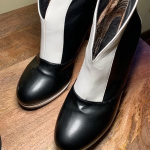 Woman’s black and white high heel booties. Approx 4 1/2 inches high. Pre-owned.